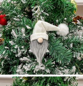 Close-up of faceless gnome Christmas ornament with white knit hat and grey beard