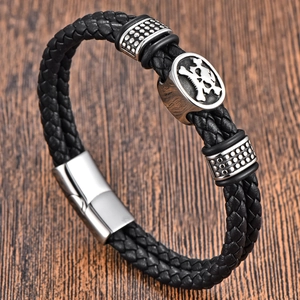 Men's black braided leather bracelet with silver skull charm and magnetic clasp