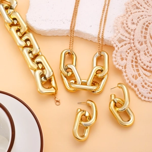 Dettaglio di un set di gioielli a catena grossa dorata con collana e bracciale