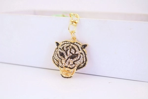 Detailed close-up of tiger head keychain with sparkling rhinestones and black enamel