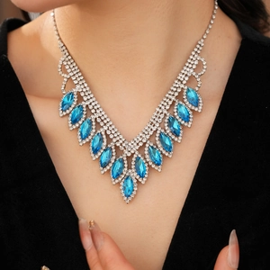 Close-up of elegant V-shaped necklace with blue marquise crystals and sparkling rhinestones