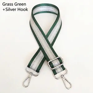Detail of adjustable grass green nylon bag strap with silver glitter stripes and metal hooks
