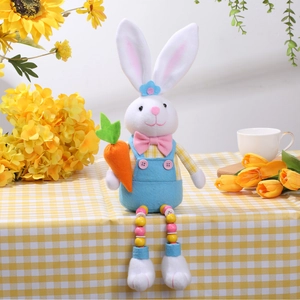 Easter bunny plush doll with wooden bead legs sitting on checkered cloth with sunflowers