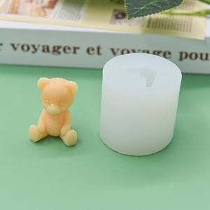 Sitting teddy bear silicone mold with textured orange bear figurine on a green background