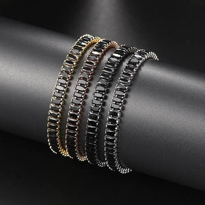 Close-up of rectangular black zircon tennis bracelets in gold, silver, and rose gold finishes