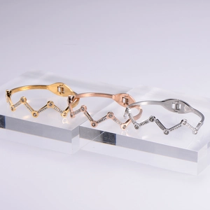 Sparkling wave-patterned 18k gold plated stainless steel bangles with pavé zirconia stones