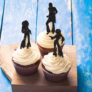 Three black glitter silhouette disco dancer cupcake toppers on a wooden stand