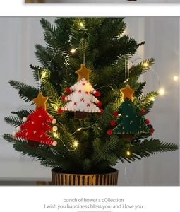 Detailed view of handmade wool felt Christmas tree ornaments with embroidery and pom poms