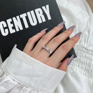 Detailed shot of an elegant S925 silver ring featuring blue teardrop and heart zircons