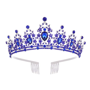 Close-up of royal blue crystal tiara with pear-cut gemstones and silver combs for bridal wear