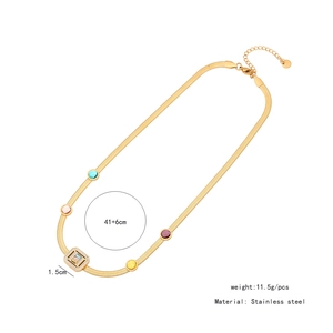 Détail du collier chaîne serpent en acier doré avec pierres colorées et pendentif zircon