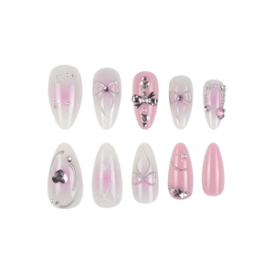 Pink and white gradient press-on nails with 3D silver bows, pearls, and rhinestones