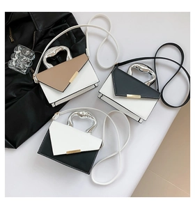 Detailed view of color-block crossbody bags with unique silver geometric metal handles
