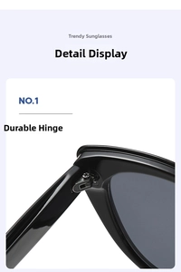 Detail showing high-gloss black frame and sturdy metal hinge structure of the sunglasses