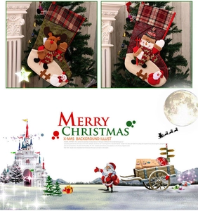 Detail of Christmas stockings with reindeer and snowman patterns hanging by a fireplace