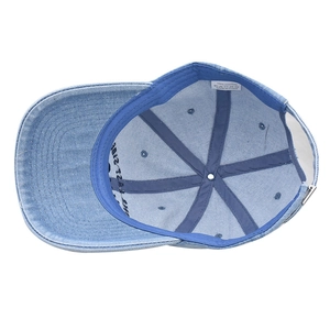 Detailed interior of denim cap with 100% cotton label and metal adjustment buckle