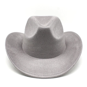 Close-up of a light gray suede cowboy hat showing intricate stitching on the curled brim