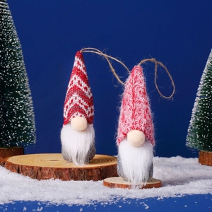 Detailed close-up of handmade Christmas gnomes with knit hats and wooden bases