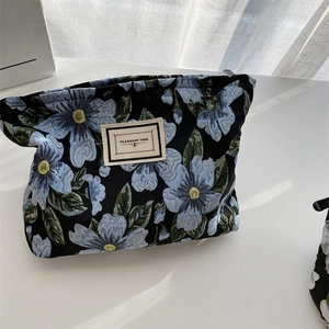Detail of blue floral jacquard fabric and brand label on retro underarm tote bag