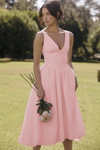 Detailed view of pink floral V-neck midi dress with ruched bodice and waist tie details