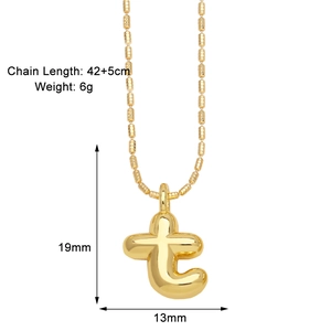 Detail of gold letter t pendant necklace with dimension labels and beaded chain texture