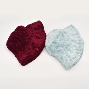 Detail of thick plush knitted bucket hats in wine red and light blue with wave texture
