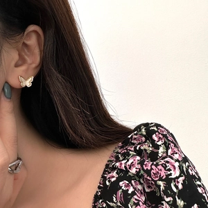 Elegant gold butterfly stud earrings with white inlay and micro-pave crystals