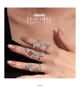 Close-up of stacked S925 silver rings with pear-shaped and square purple zircon stones