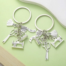Detailed view of silver sewing tool pendants including scissors and sewing machine