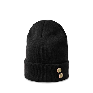 Detail of black ribbed knit beanie featuring green marble decorative square buttons