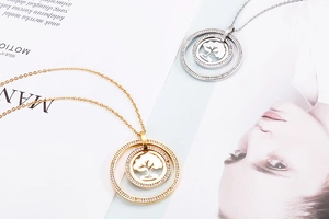 Detailed close-up of gold and silver Tree of Life necklaces with sparkling rhinestones