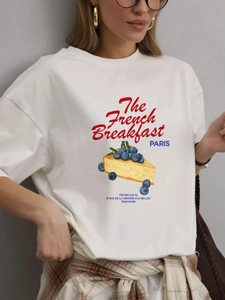 Close-up of white cotton T-shirt featuring French breakfast cake and blueberry print