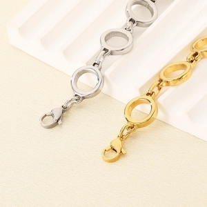 Detailed view of interconnected gold and silver stainless steel rings with lobster clasp