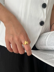 Close-up of golden 925 sterling silver heart ring with beaded texture on model's finger