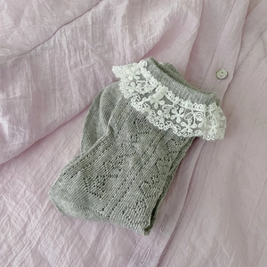 Detail of grey knitted short socks featuring delicate white lace trim and hollow-out texture