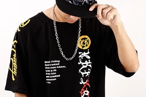 Close-up of black cotton t-shirt with hip-hop style graphic text and colorful prints