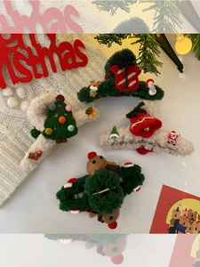 Close-up of plush Christmas claw clips featuring 3D reindeer and tree designs