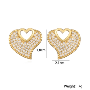 Detail view of heart-shaped gold studs with clear zircons, size 1.8cm by 2.1cm and 7g weight