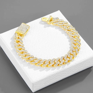Close-up of a 12mm golden iced-out Cuban chain necklace on a white jewelry box