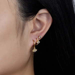 Detailed close-up of 925 silver gold-plated evil eye earrings set with blue zircons