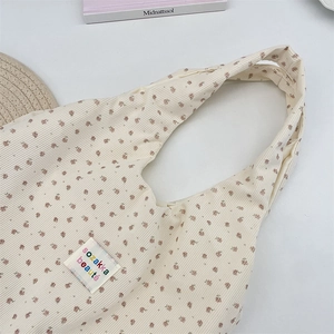 Detailed macro view of beige corduroy fabric with vintage floral print and brand label