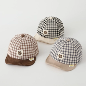 Close-up of soft cotton plaid baby baseball hats with bear patches and fabric texture
