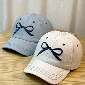 Denim baseball caps with bow embroidery in light blue and beige colors for women