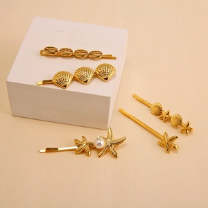 Golden ocean theme hair clip set featuring starfish and shells with faux pearls