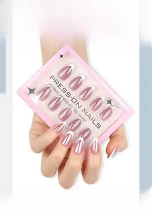 Detailed view of French gradient press-on nails with white tips in pink branded packaging