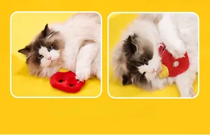 Interactive plush dog toy in bright red and yellow colors being played with by a cat