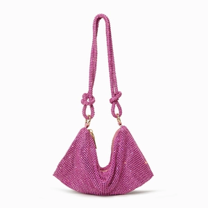 Detail of magenta rhinestone handbag with crystal knots and shimmering evening texture