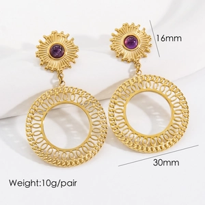 Detail view of gold sunburst earrings with purple stone and 30mm open hoop pendant