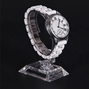 Classic white ceramic quartz watch with silver metal case and Roman numeral dial on stand