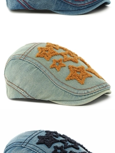 Macro detail of denim flat caps featuring plush star patches and contrast stitching